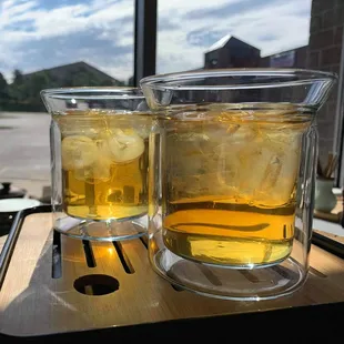 two glasses of tea on a table