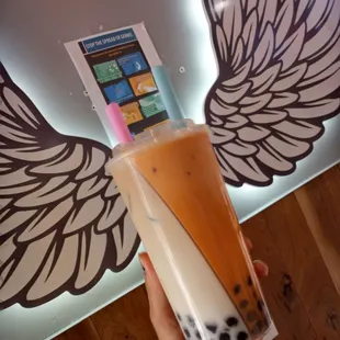 a hand holding a cup of bubble tea