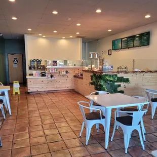 the inside of a restaurant with tables and chairs
