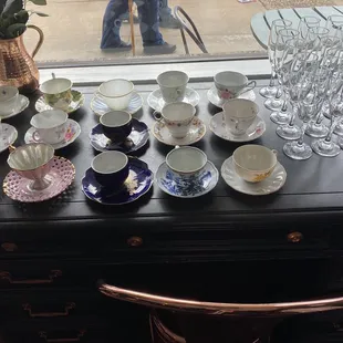 a collection of tea cups and saucers