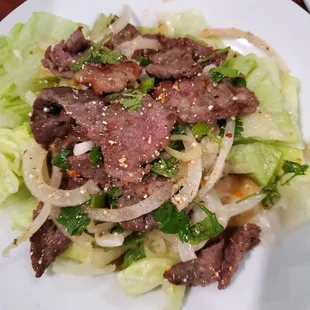 Crying Tiger - Slice beef with lime, rice powder, chili pepper, fish sauce, tamarind, onions, cilantros, tossed together.