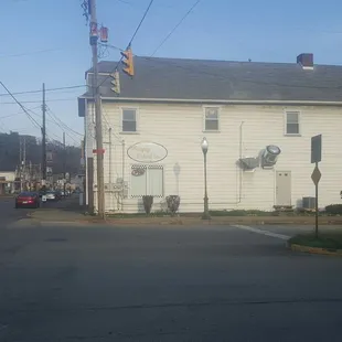 a white house with a clock on the front