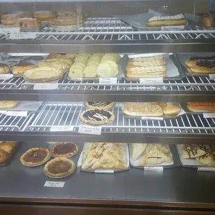 a variety of baked goods in a display case