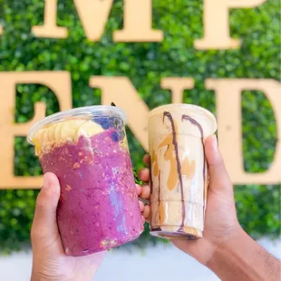 two people holding up their drinks