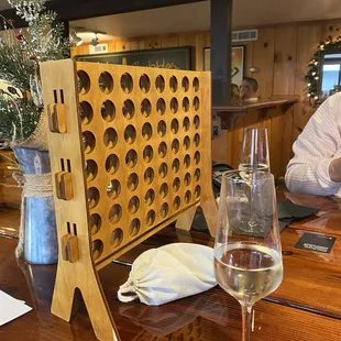 a wine glass and a wooden wine rack