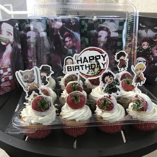 a display of cupcakes with strawberries