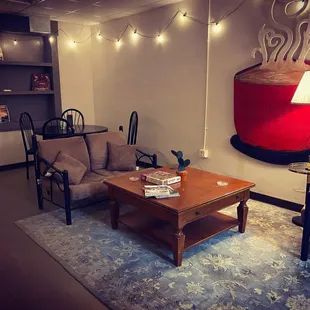a living room with a coffee cup on the wall