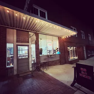 the outside of a coffee shop at night