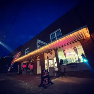 the outside of a cafe at night