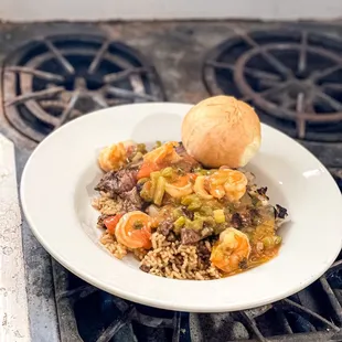 Friday night special, dirty Bernie! Strips of ribeye steak on a bed of dirty rice with shrimp creole on top!