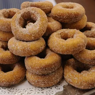 a pile of sugar coated donuts