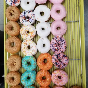 a variety of donuts on a cooling rack