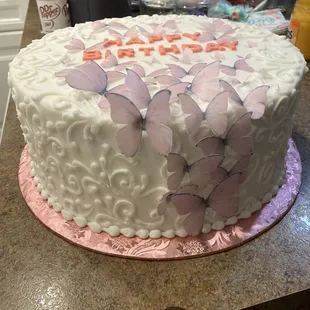a cake decorated with butterflies