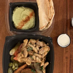Chicken shawarma with spicy hummus and vegetables.