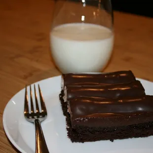 a piece of chocolate cake and a glass of milk