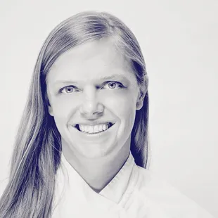 a black and white photo of a smiling woman