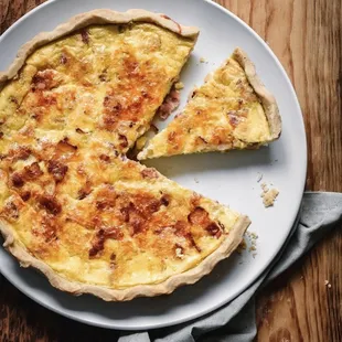 a slice of quiche on a plate