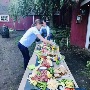 two women preparing a table of food