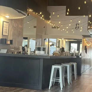 a view of a bar with stools