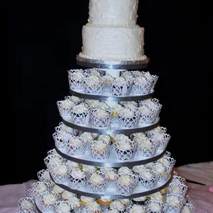 a wedding cake and cupcakes