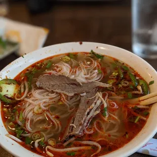 a bowl of soup with meat and noodles