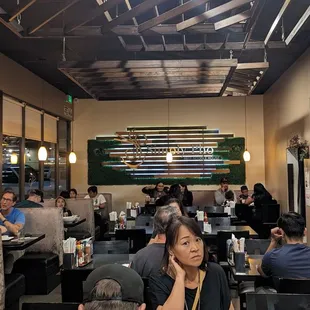 people sitting at tables in a restaurant