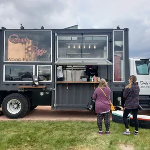 two people standing in front of it