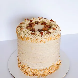 Delicious 3-layer Carrot Cake with Cream Cheese Frosting and decorated with pecans and toasted coconut!