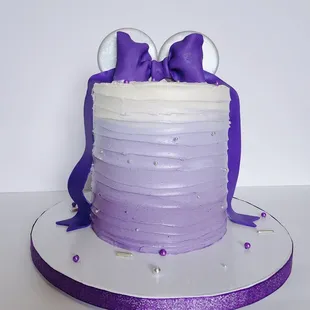 This Minnie Mouse-inspired purple, white, and silver cake was a fun surprise for the birthday girl.