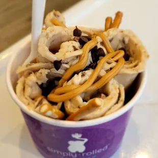 a bowl of ice cream with pretzels