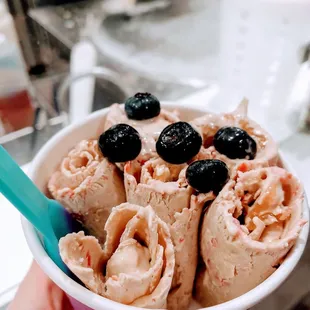 Matcha green tea with almond and raspberries mixed in, lavender honey rolled in, and blueberries on top.