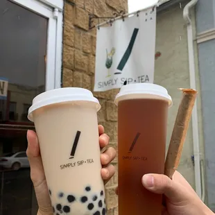two cups of bubble tea and a cigar