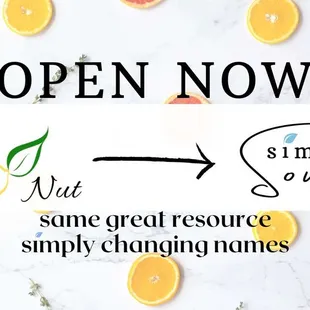 an open now sign with oranges