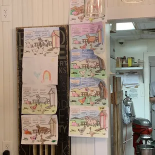 A cute gallery of menus colored by tiny patrons.