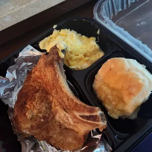 Porkchop,  scrambled eggs and a homemade biscuit.