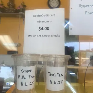 two cups of coffee and a price sign