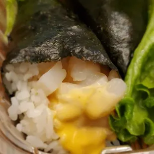 two pieces of sushi on a bed of rice and lettuce