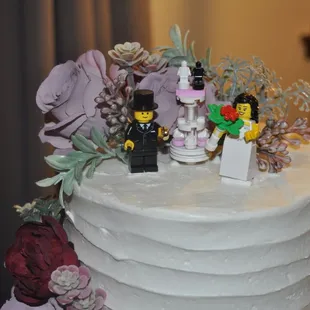a wedding cake decorated with legos