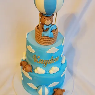 a cake with a teddy bear in a hot air balloon