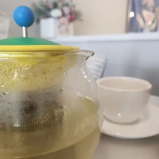 a tea pot with a tea ball in it