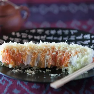 a plate of sushi and chopsticks