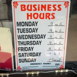 a business hours and hours sign