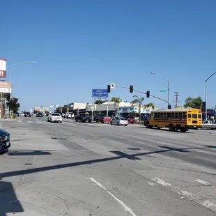 a busy street with cars and a school bus