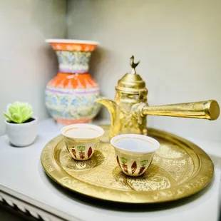 wo cups of tea on a gold tray