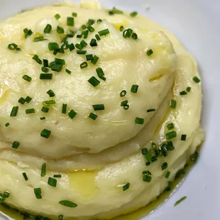 a pile of mashed potatoes topped with chives