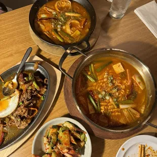 Budae jigae, kimchi dumpling stew, beef bulgogi, kimchi pickled cucumber
