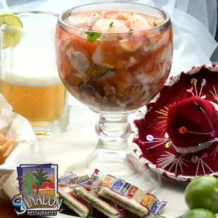 Campechana Especial! This delicious cocktail contains cooked shrimp, octopus, snail, aguachile shrimp, cucumber, pico de gallo, and oysters!