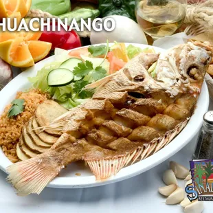 Our Huachinango Frito! Fried Red Snapper served with salad, rice, and house potatoes.