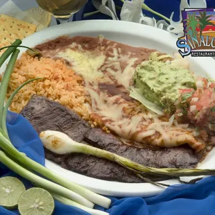 Our popular Tampiqueña! Delicious carne asada alongside an enchilada, guacamole, rice, beans, and pico de gallo!