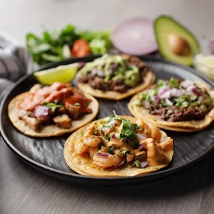 a variety of tacos on a plate